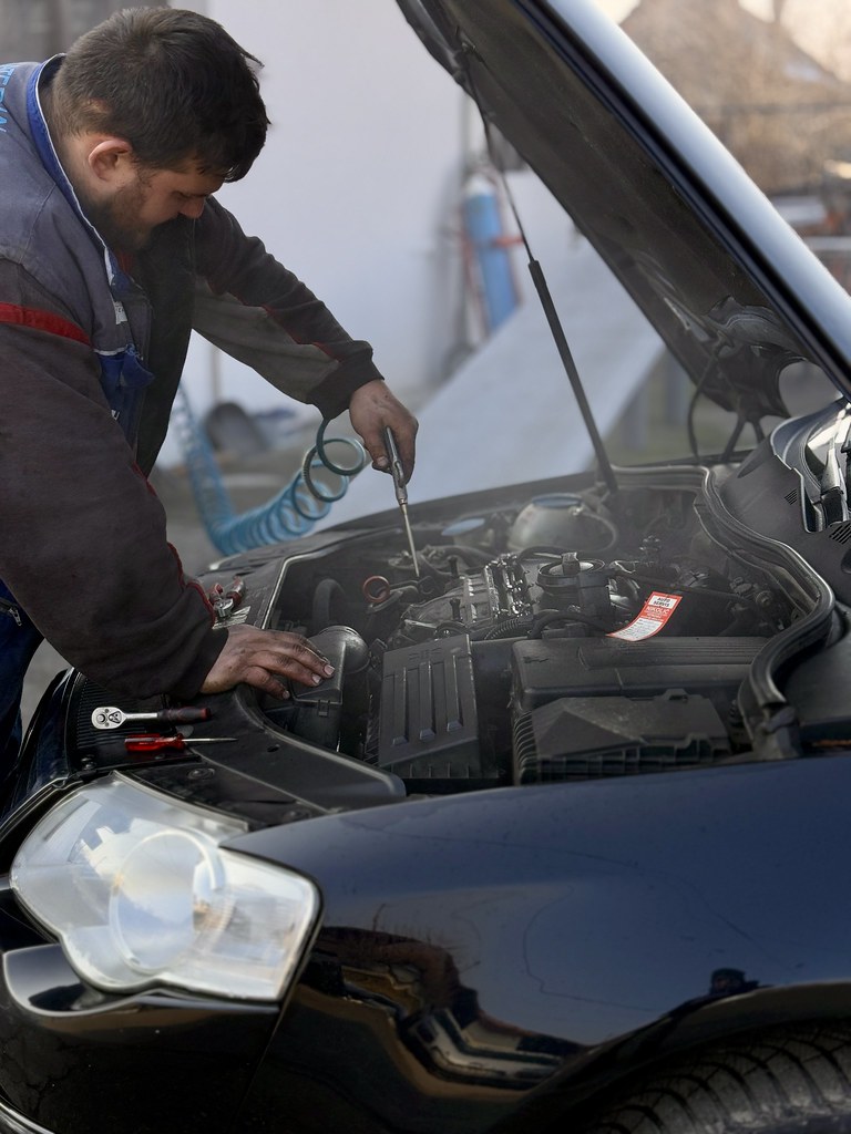Professional automotive mechanic working on vehicle service with expert care